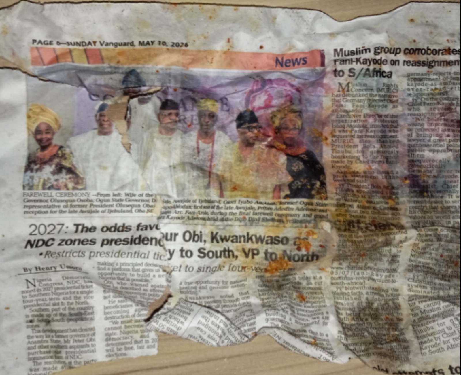 A stained Vanguard newspaper from 10 May 2026 used as a suya wrapper